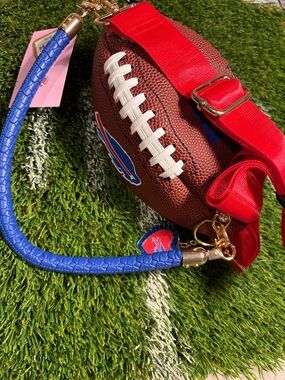Bills  Football Crossbody Bag with Blue Strap and Red leather purse handle.